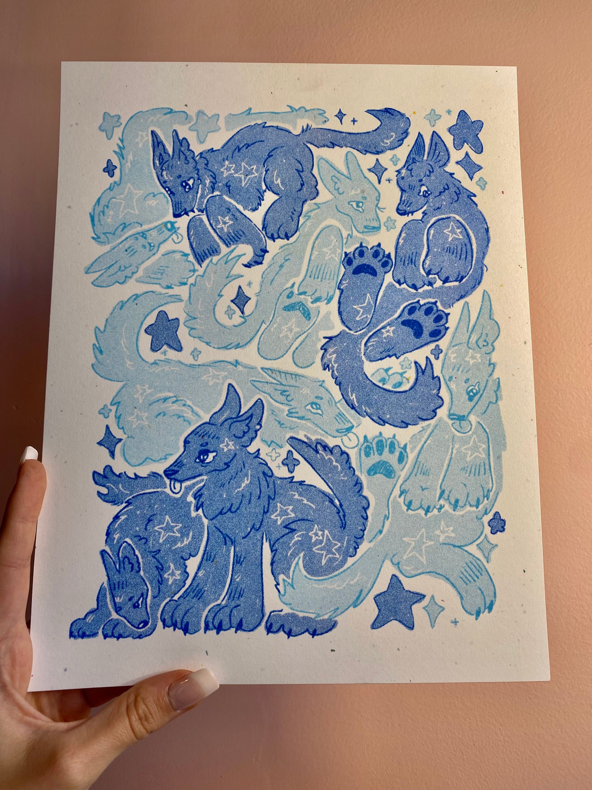 Sheet of blue wolf illustrations on a beige background